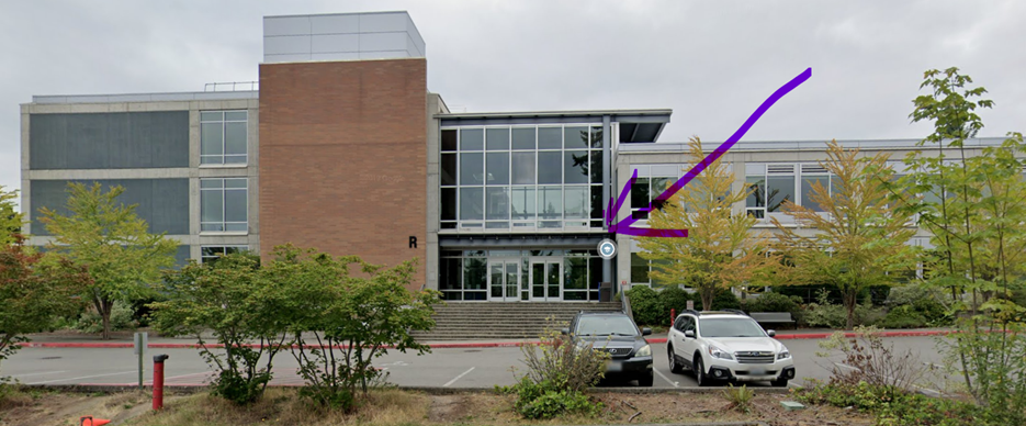 A building with cars parked in front of it

Description automatically generated